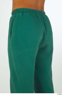 Nathaniel buttock dressed green jogging pants sports thigh 0002.jpg